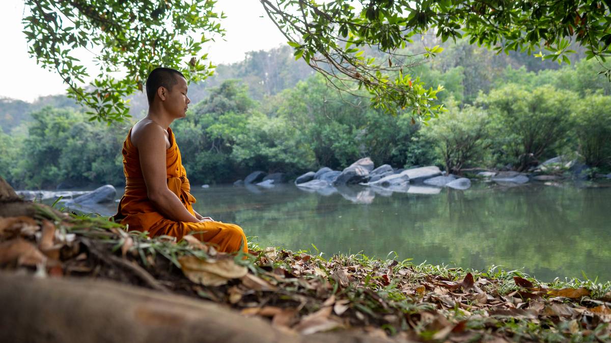 Photo of smiling woman practicing deep breathing outdoors