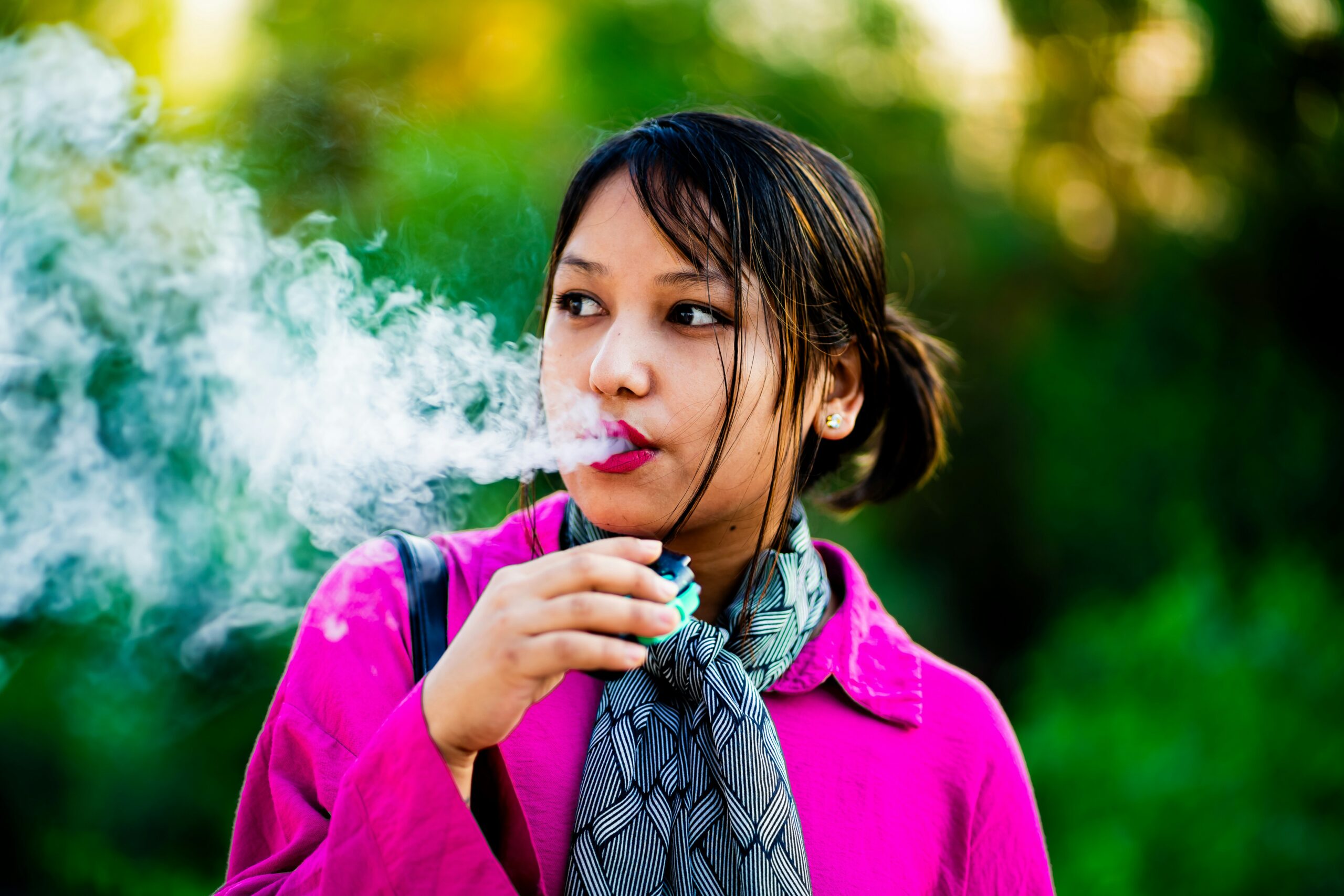 A young girl smoking vape outdoors in Dubai