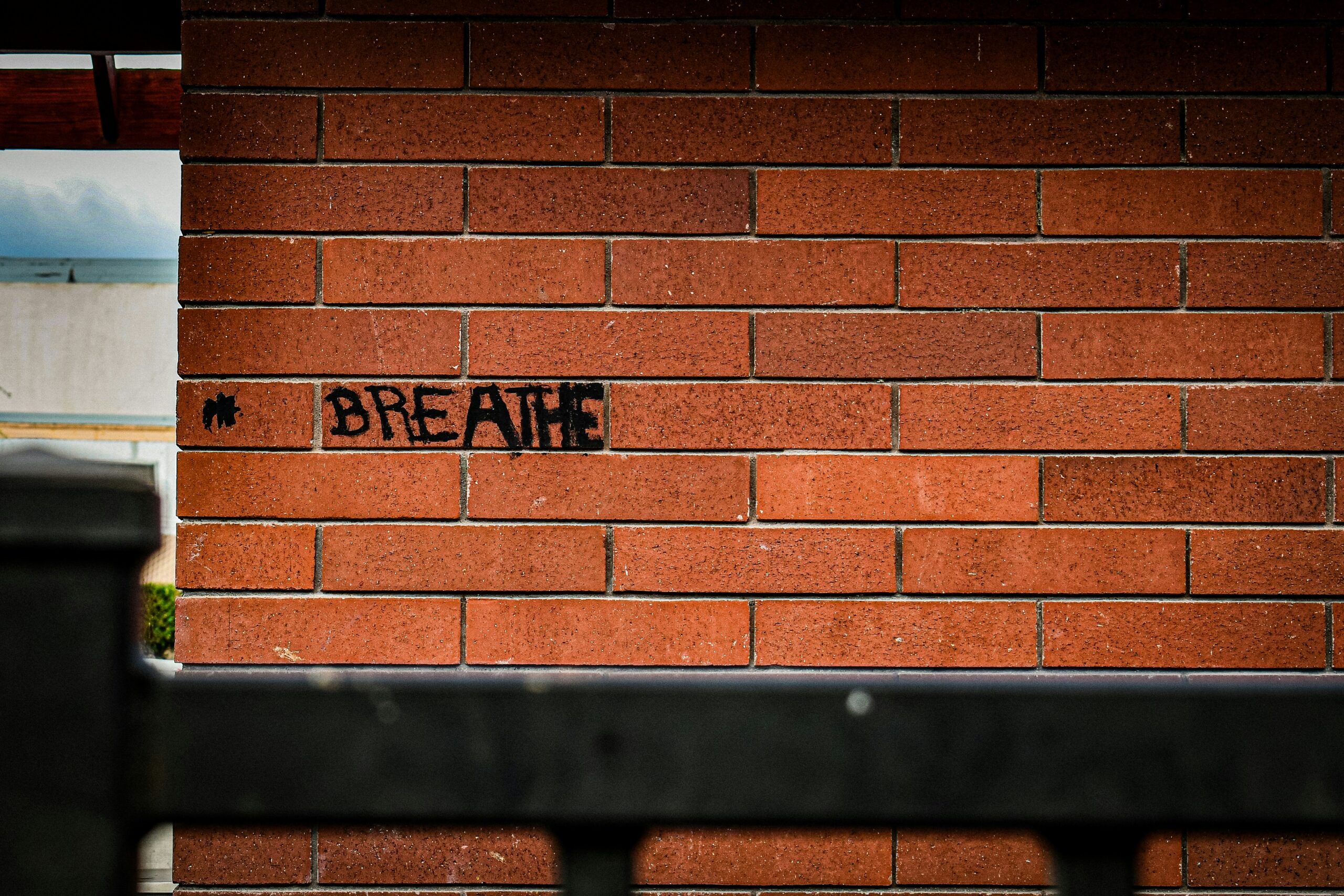 "Breathe" graffiti on a brick wall