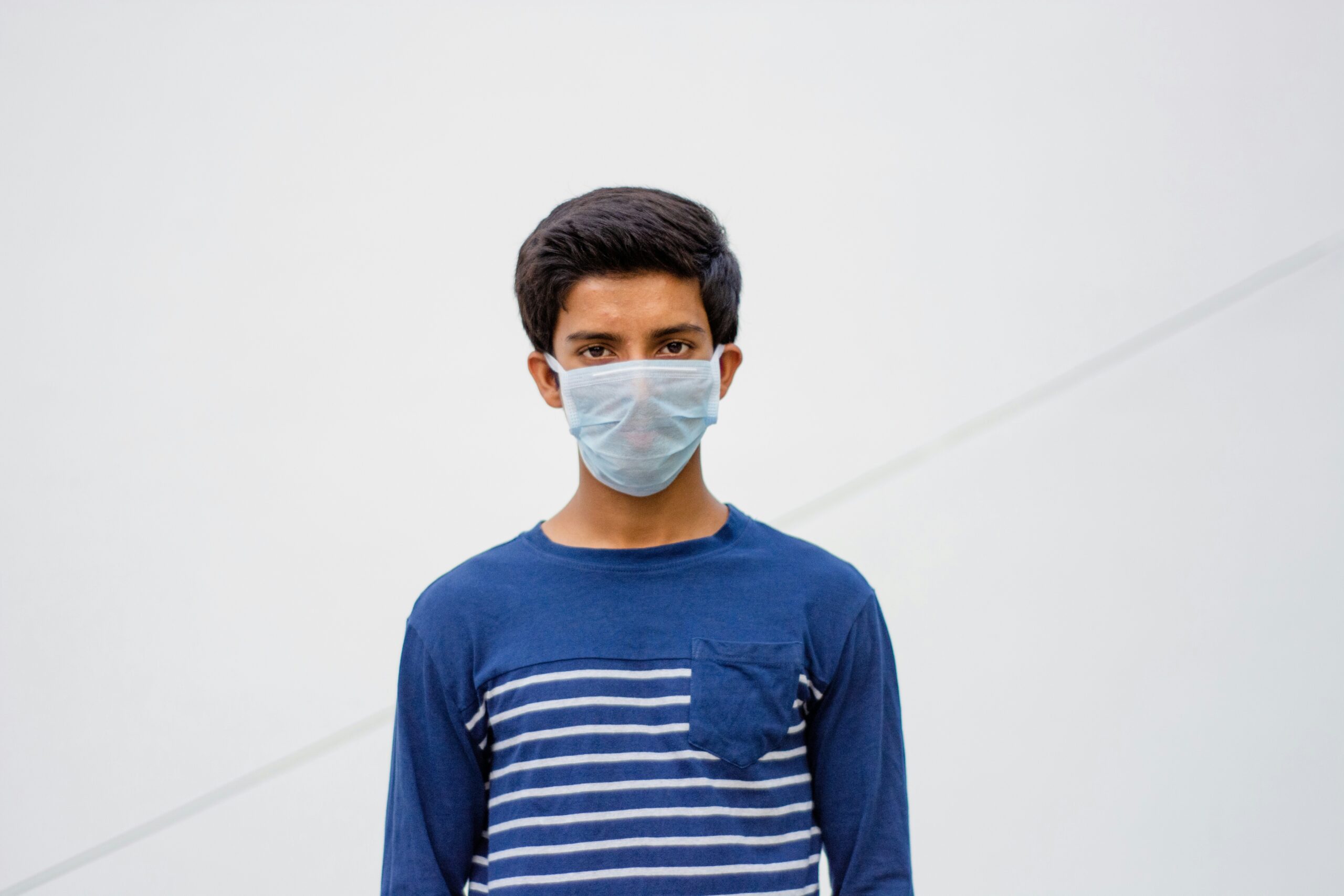 Young Man wearing a surgical mask because save his life from the pandemic