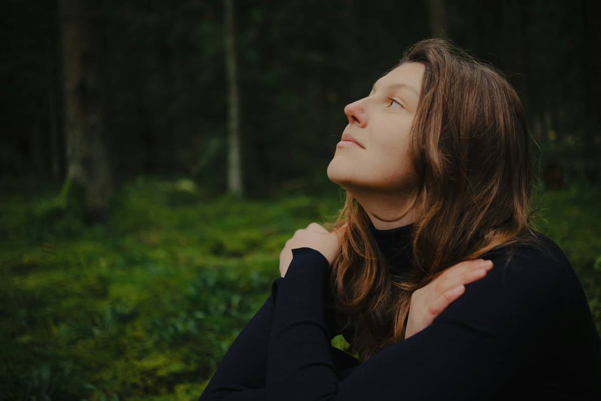 A person practicing diaphragmatic breathing exercises outdoors